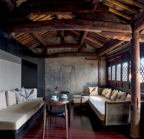 a living room with a couch and a table at Dali Sky Valley Heritage Boutique Hotel in Dali