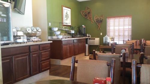 a dining room with chairs and a counter and a bar at The Inn at Tomichi Village in Gunnison