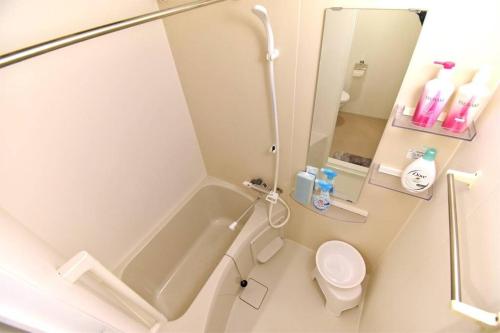 a bathroom with a shower and a toilet and a sink at IDstay大森301 in Tokyo