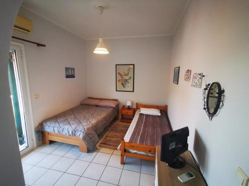 a bedroom with a bed and a table in it at Marilena House Plataria in Plataria