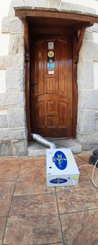 a pizza box sitting in front of a wooden door at Casa Rural Lagun Etxea in Pobes