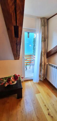 a room with a table and a door with a patio at Casa Crown in Braşov