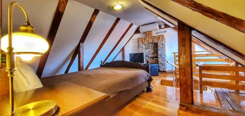 a bedroom with a large bed in a attic at Casa Crown in Braşov