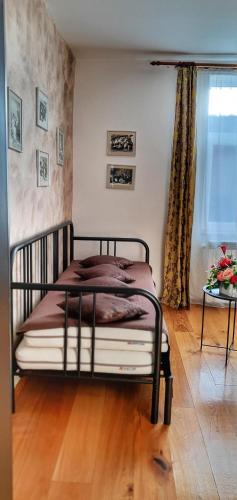 a bedroom with a bed in a room with a window at Casa Crown in Braşov