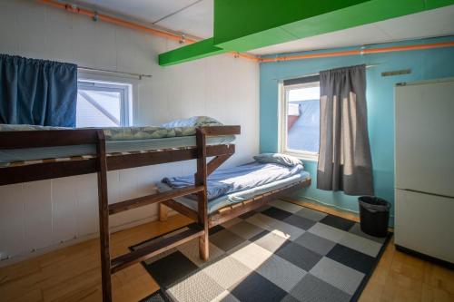 a room with two bunk beds and a window at Tromso Activities Hostel in Tromsø