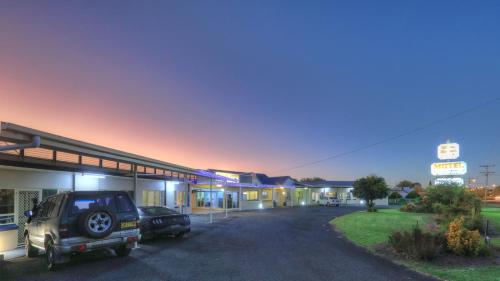 a car parked in front of a gas station at Glen Innes Motel in Glen Innes