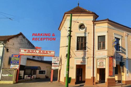 an old building with a sign for a parking and reception at BOUL ROSU RESIDENCE free private parking in Arad