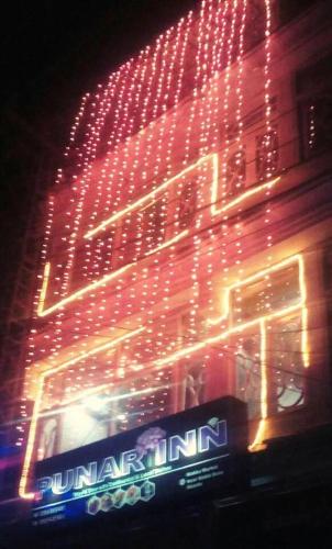 a building with red lights on the side of it at Punar Inn Hotel in Skardu