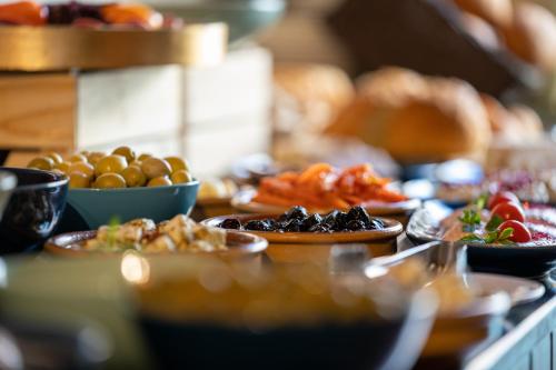 a buffet with plates of food on a table at V Boutique Hotel in Jeddah