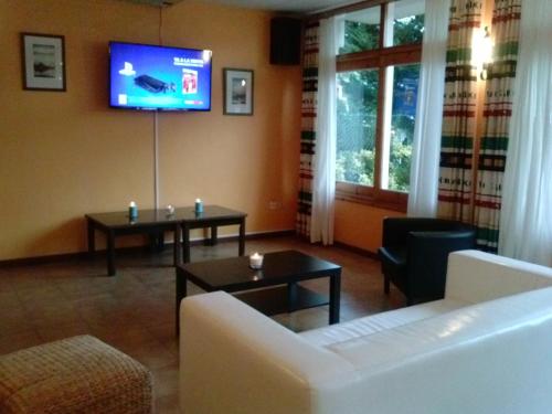a living room with a couch and a tv at Payet Apartments in L'Estartit