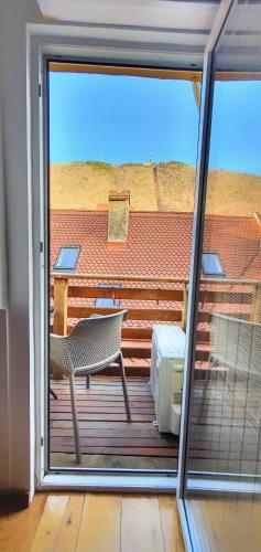 a balcony with a chair and a table on a deck at Casa Crown in Braşov
