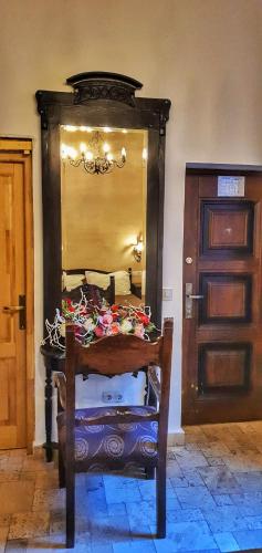 a wooden chair in a room with a door at Casa Crown in Braşov