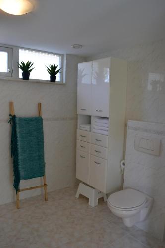a bathroom with a white toilet and a window at Studio 38 in Zandvoort