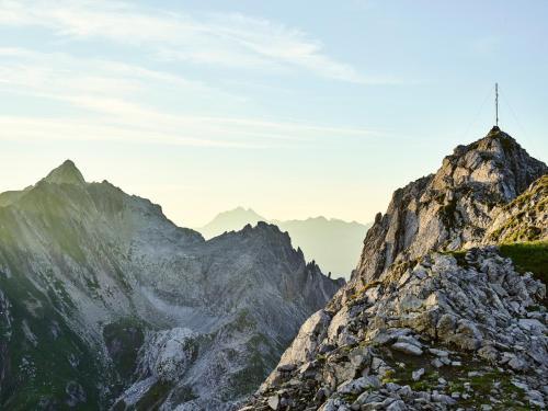 a mountain top with a cross on top of it at Arlberg Lodges in Stuben am Arlberg
