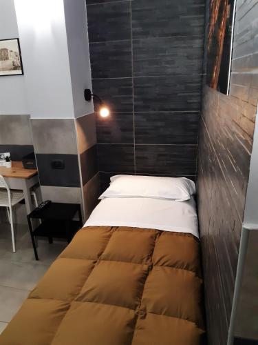 a bed with a wooden headboard in a room at La Montrucca Camere in Caselle Torinese