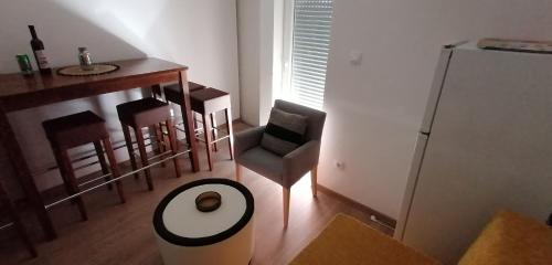 a living room with a table and chairs and a counter at Novalja centar in Novalja