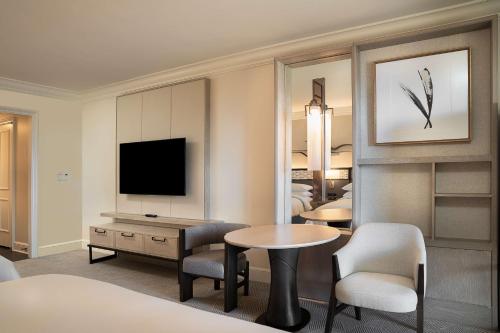 a hotel room with a television and a table and chairs at Park Hyatt Aviara in Carlsbad