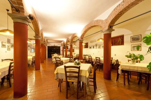a restaurant with tables and chairs in a room at Agriturismo La Lupa in Madonna della Provvidenza