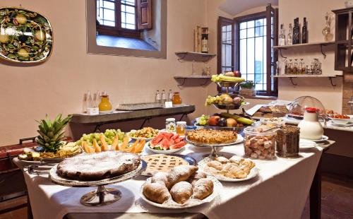 a table filled with lots of different types of food at Palazzo Leopoldo Dimora Storica & Spa in Radda in Chianti
