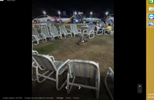 a bunch of chairs sitting in a field at Centurion Hotel in Nārān
