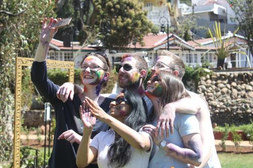a group of people with paint on their faces posing for a picture at Savoy - IHCL SeleQtions in Ooty