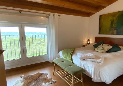 um quarto com uma cama e uma grande janela em Agrovillaujue apartamentos rurales em Ujué