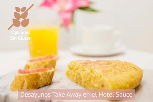 two pieces of bread and a glass of orange juice at Apartamentos Sabinas El Pilar in Zaragoza