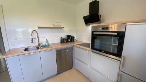 a small kitchen with a sink and a microwave at Bs Living Apartment in Braunschweig