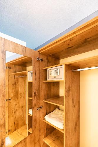 a room with wooden walls and wooden shelves at Hotel La Mirabelle close to Europa Park in Rheinhausen