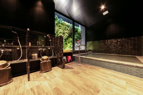a large bathroom with a shower and a tub at Sanco Inn Grande Nagoya -HOTEL & SPA- in Nagoya
