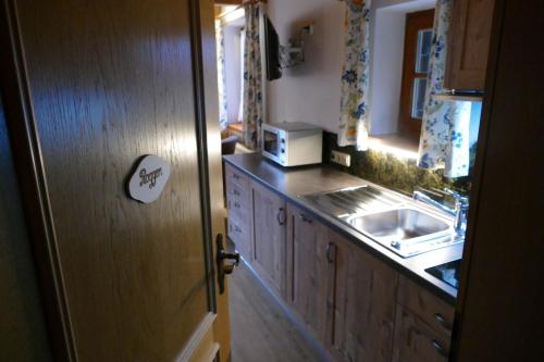 a kitchen with a sink and a microwave at Plenkhof in Ruhpolding