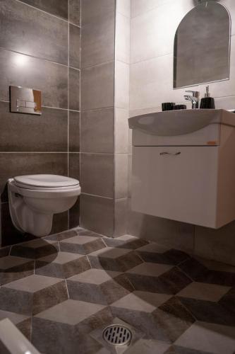 a bathroom with a toilet and a sink at Villa Clock Tower - Саат Кула in Ohrid