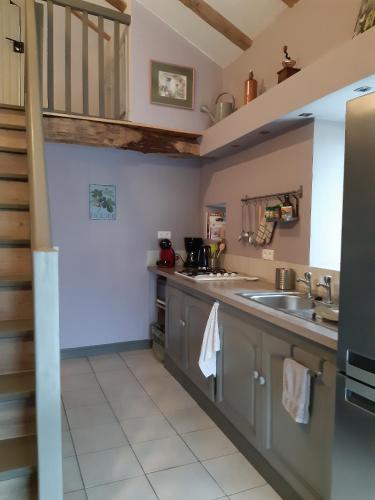 a kitchen with a sink and a counter at Le Figuier in Le Lindois