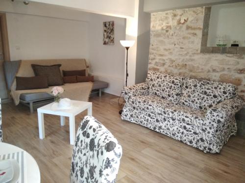 a living room with a couch and a table at LOUKIA'S HOUSE in Skala Kallirakhis