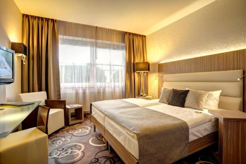Säng eller sängar i ett rum på NordWest-Hotel Bad Zwischenahn