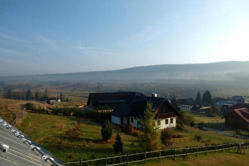 a town on a hill with a road and a highway at Rodinný apartmán v srdci Šumavy in Kvilda