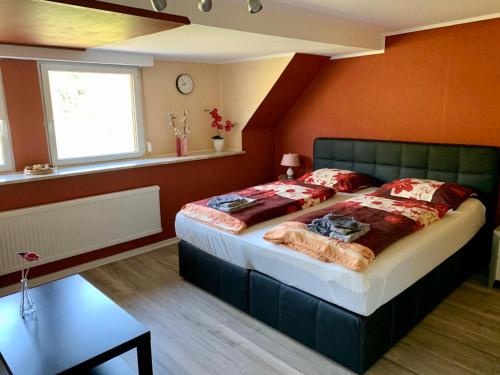 a bedroom with a large bed in a room at Gästehaus Mona Lisa in Neef