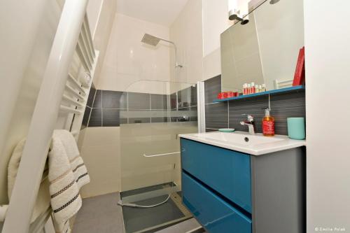 a bathroom with a sink and a shower at Comme à la Maison - DE LA TOUR in Saint-Quentin