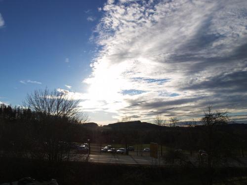 a cloudy sky with cars parked in a parking lot at Ferienwohnung Beate 1 in Ziemetshausen