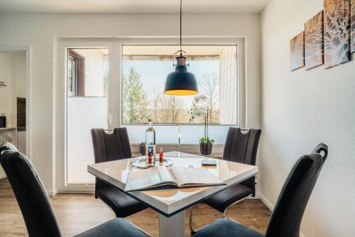 a dining room with a table and chairs and a window at Walpurgis Hexe in Braunlage