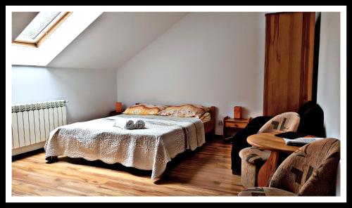 a bedroom with a bed with a cat laying on it at Leśne Berdo Przysłup in Cisna