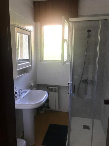 a bathroom with a sink and a shower at Villa Amelia in Llanes