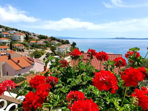 a view of a town with red flowers at Apartments Jakšić in Trogir