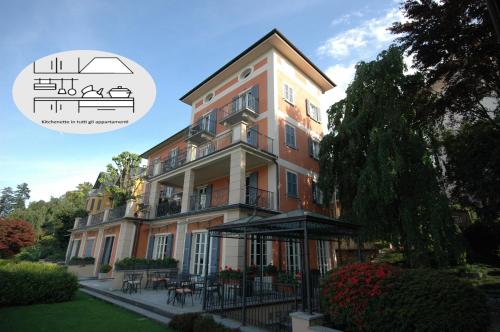 a large building with a balcony on the side of it at Hotel Residence La Luna Nel Porto in Stresa