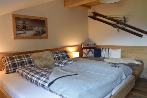 a bedroom with a large bed with a couch at Fuchsbauer in Hopfgarten im Brixental