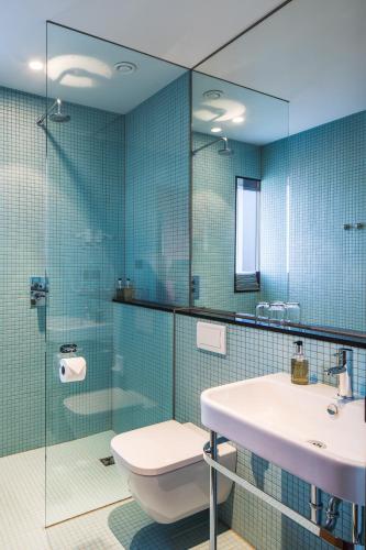 a bathroom with a sink and a glass shower at Drangar Country Guesthouse in Drangar