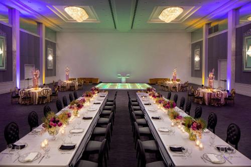 a banquet hall with long tables with flowers on them at Hyatt Regency Grand Reserve Puerto Rico in Rio Grande