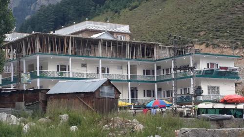 a large white building with airus at Kunhar View Hotel in Nārān