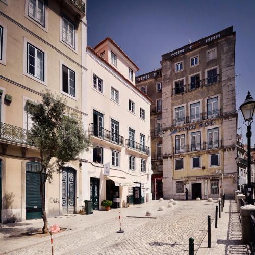 a cobblestone street in a city with tall buildings at Lisbon Story Guesthouse in Lisbon