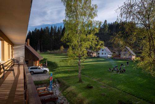 a view of a yard with a house and a car at Penzion Limba in Liptovský Ján